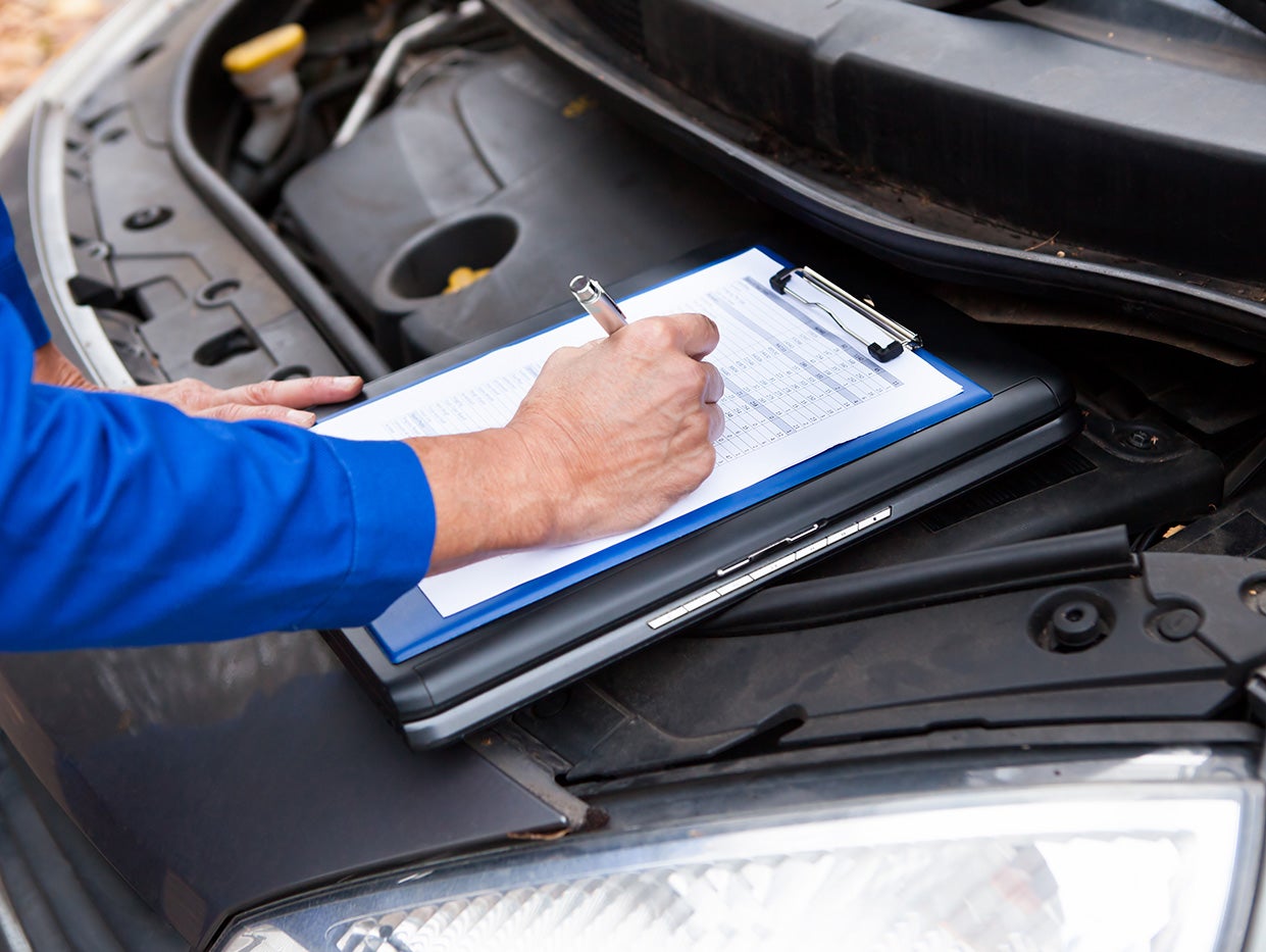 Technician performing winter maintenance checks on a vehicle